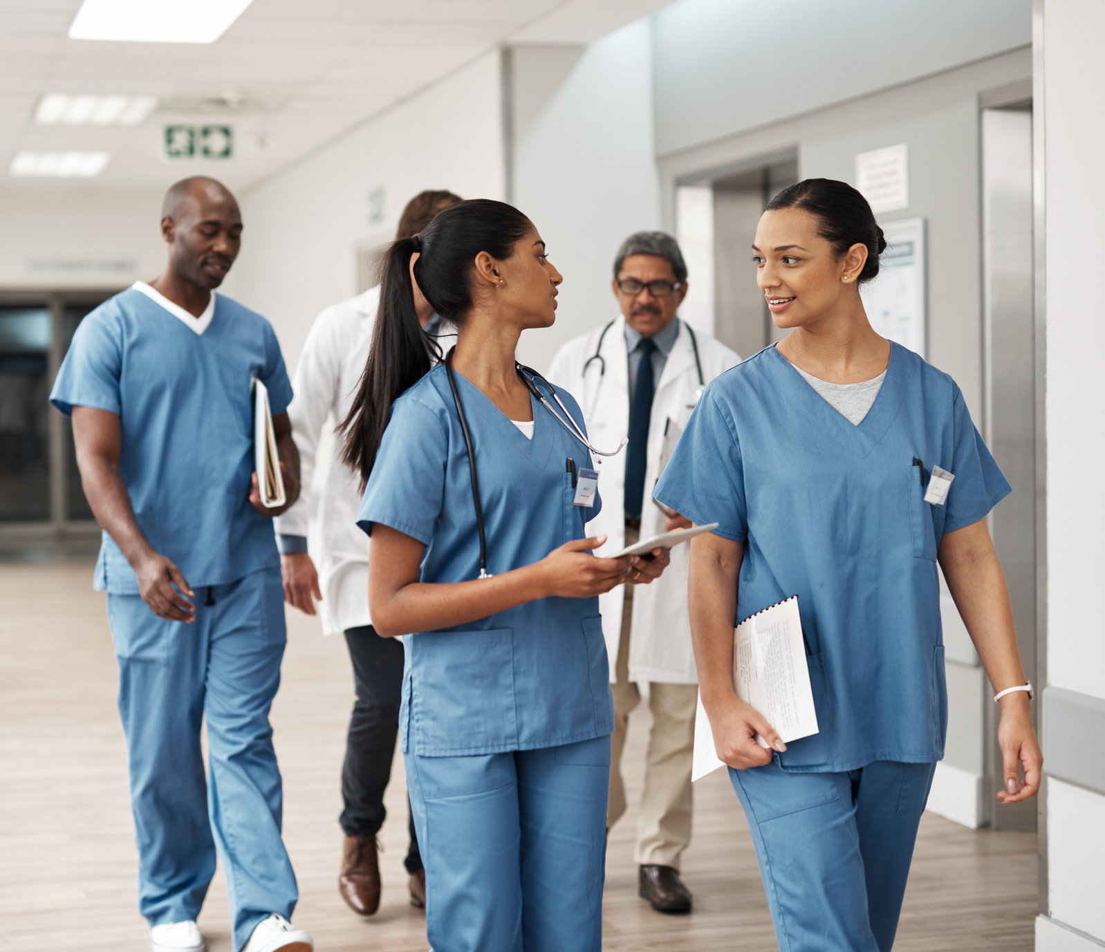 Nurses walking together down a hallway